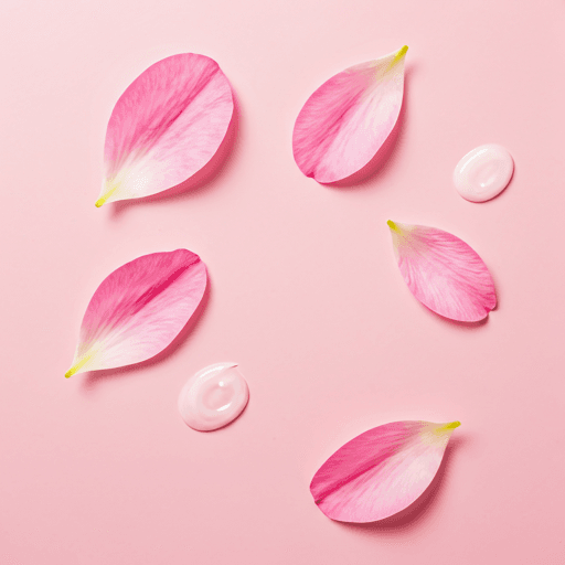 Soft pink petals and skincare texture background